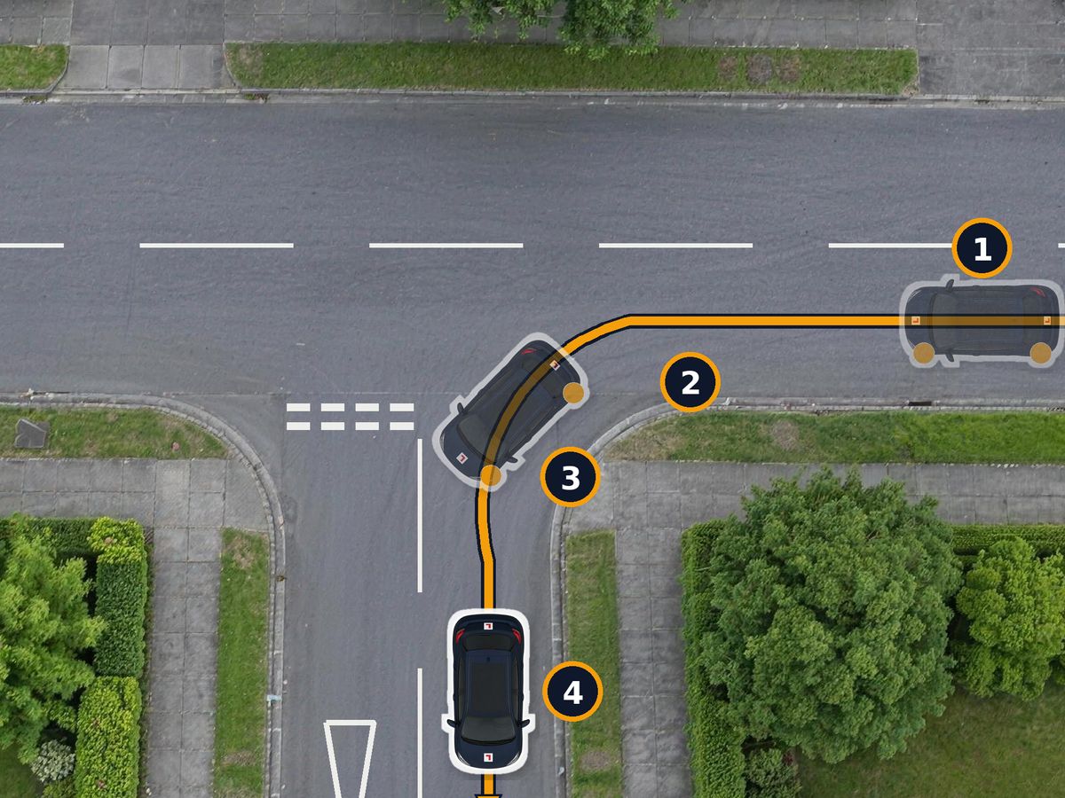 A T-junction from above. The car drives along the main road signalling left, keeps to the left as it slows, then turns into the side road and straightens up on its left side.
